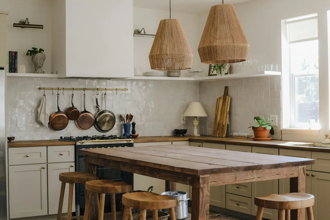 Warm kitchen with island and pendant lights