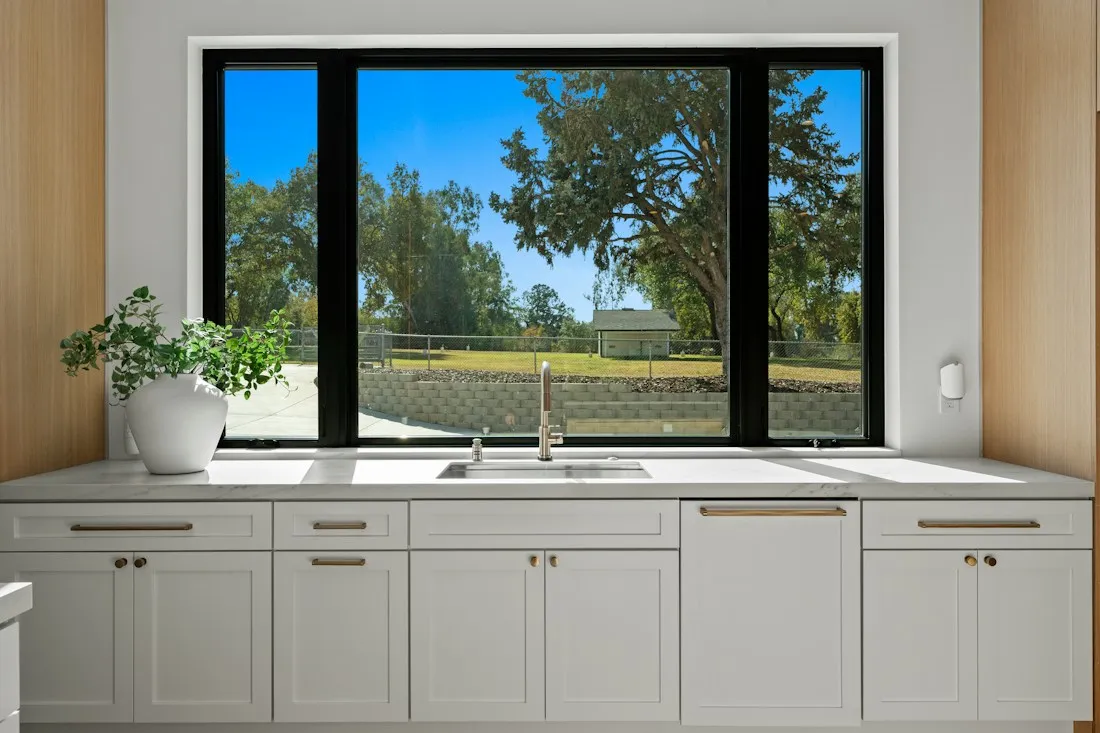 Kitchen sink beneath a large window